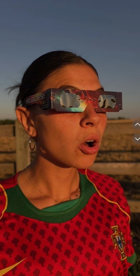 Woman in Helioclipse glasses looking up at the eclipse