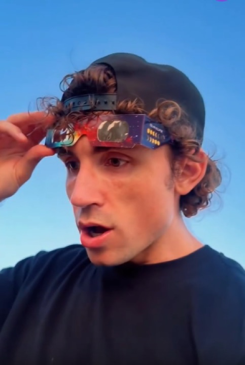 Man lifting Helioclipse glasses after watching the eclipse